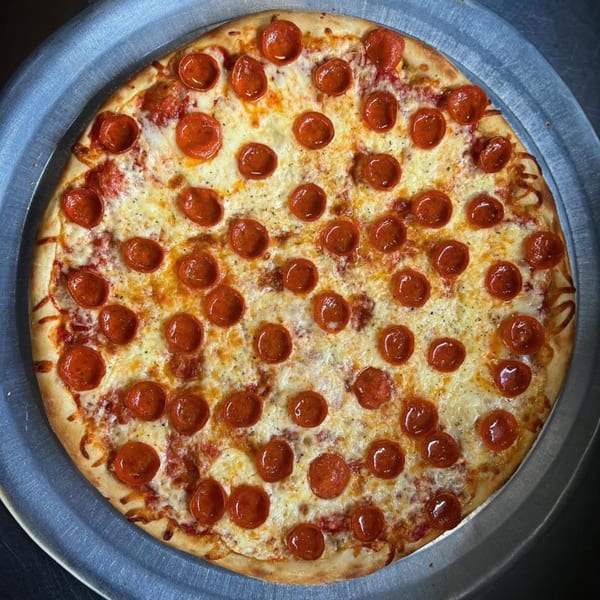 A whole pepperoni pizza from Genovas Italian Restaurant & Pizza, with melted cheese and a crispy crust.